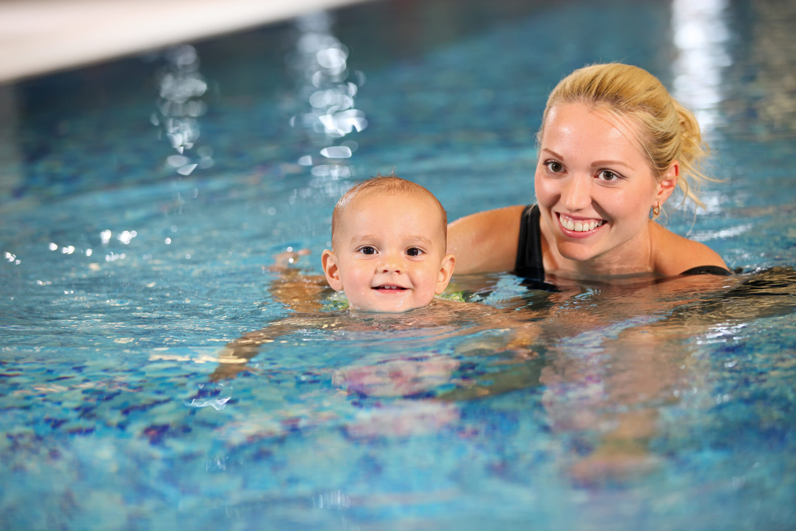 Mother and little son enjoying swimming